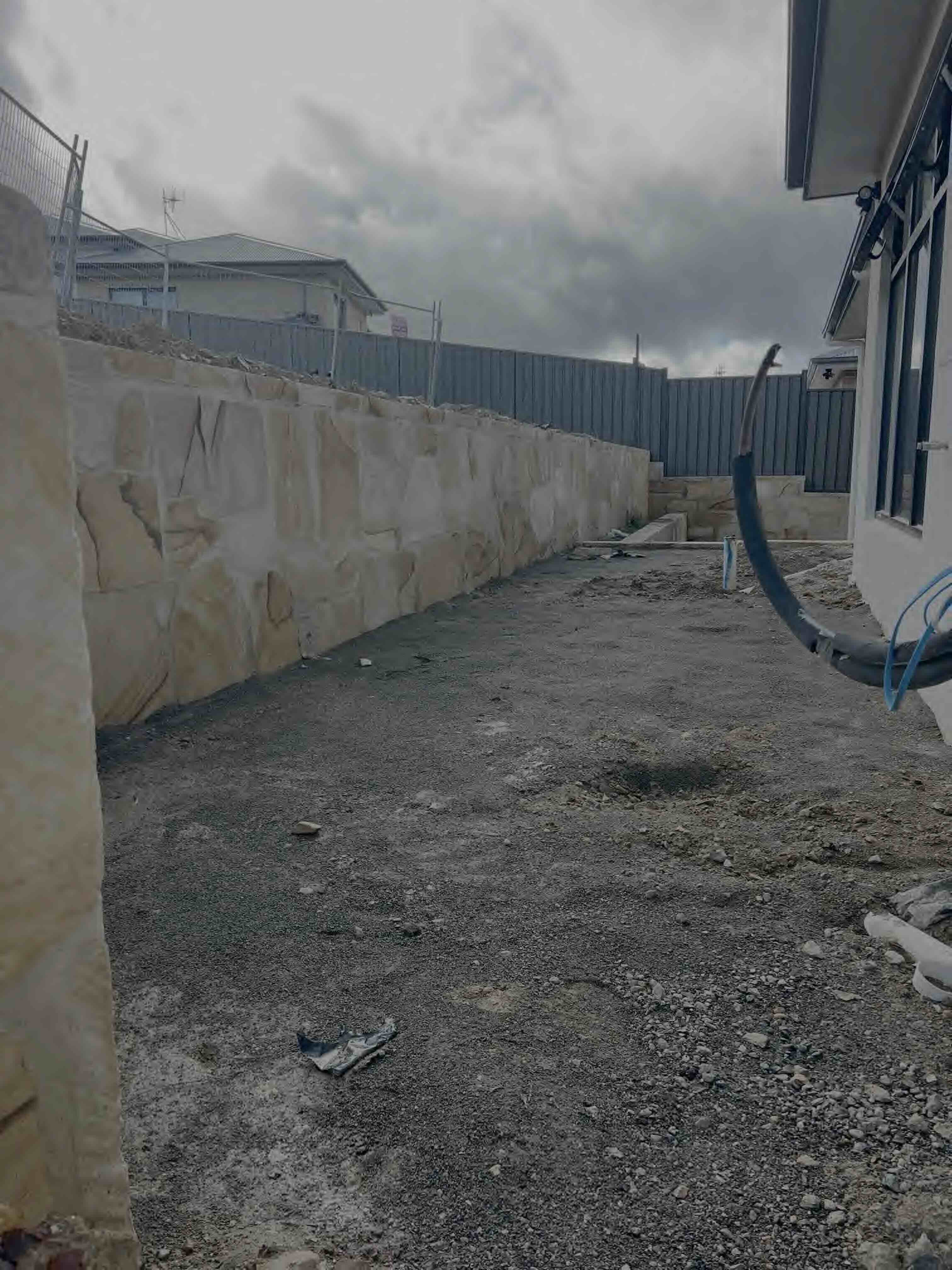 Quality texture rendering and stone cladding work on residential property demonstrating professional masonry services in Canberra