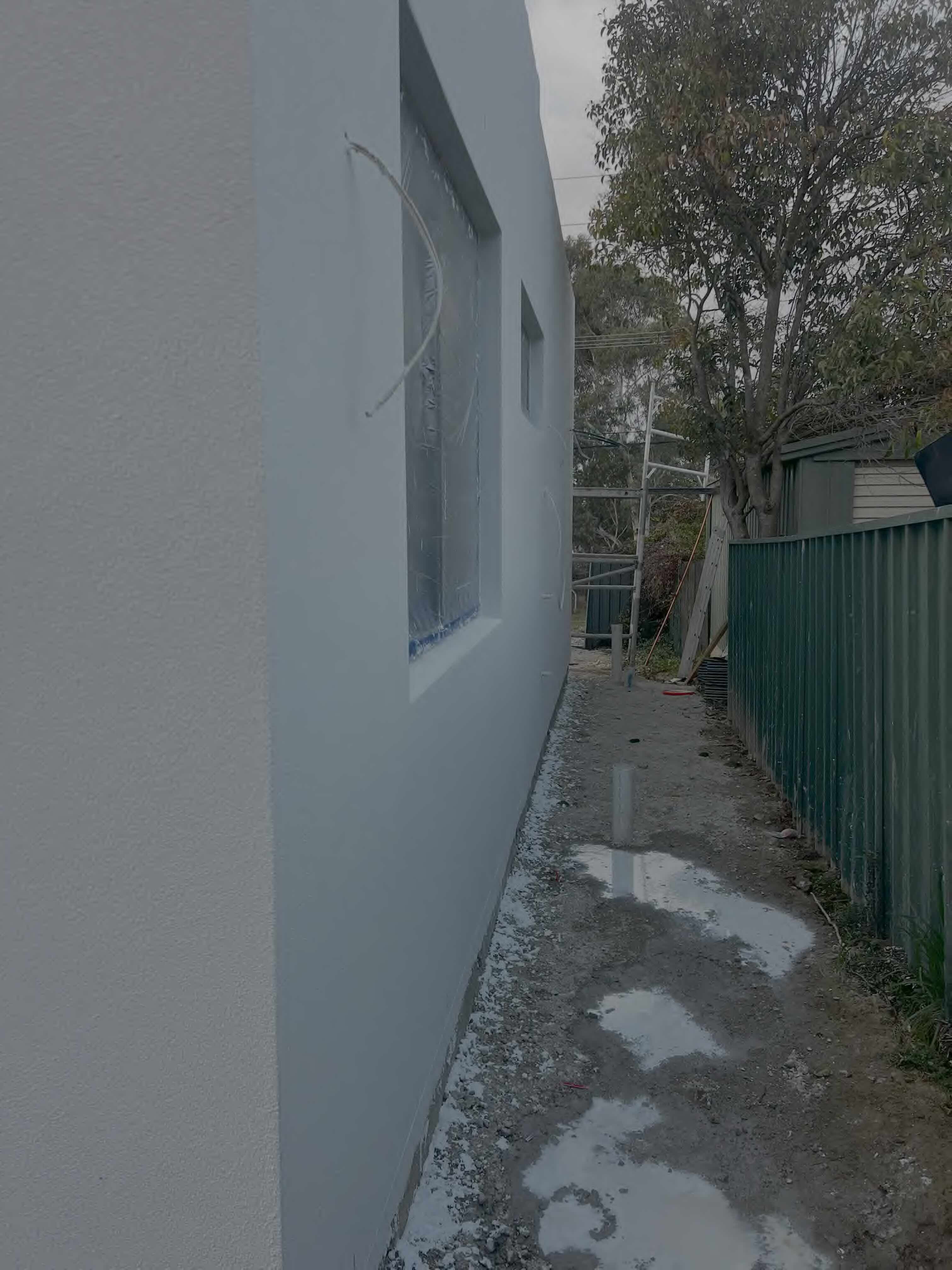 Completed rendering project with foam cladding and stone cladding showing texture finish on commercial building in Canberra